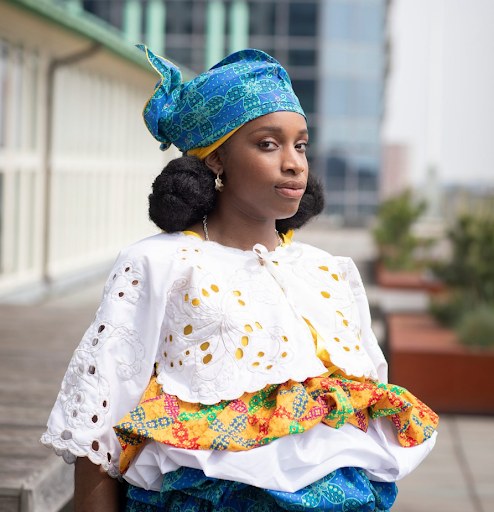 Nyanga in traditional clothing with Rotterdam in the background